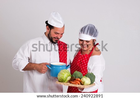 Smiling Italian Chief cook and Handsome Dark Hair Coo ky are Preparing Vegetable Soup Isolated on White Background