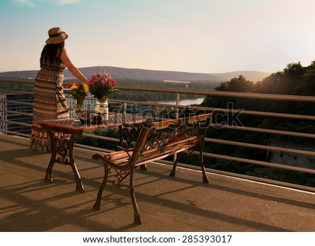 Side View of Woman Standing at Balcony and Looking Away