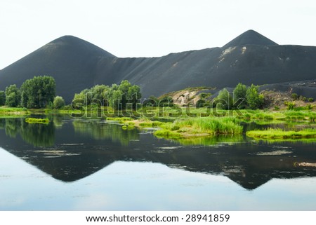marsh and the black mountains of slags in Kazakhstan, Asia