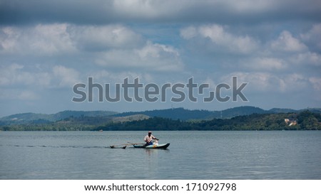 KOGGALA Lake, SRI LANKA-January 13: Local Sri lankiets sails on a boat on a tropical lake January 13 , 2013 in Koggala lake,