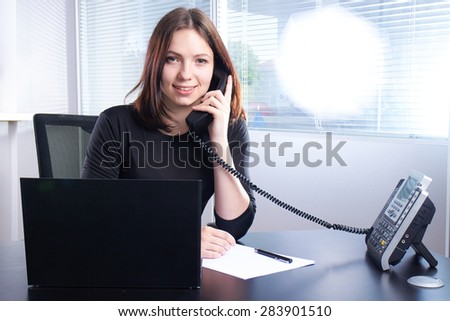 girl in black talking on the phone