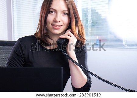 girl in black talking on the phone