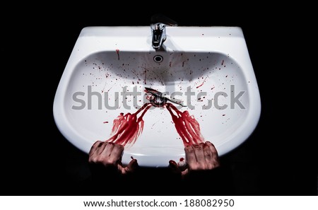 Suicide concept - bleeding hands and knife in a sink