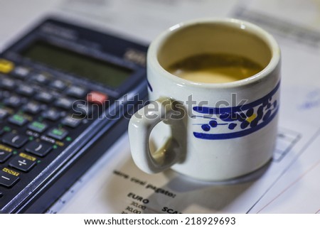 Calculation of the utility bills. Scene with bills, calculator and coffee
