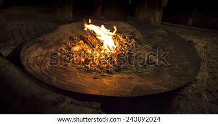 Fire in a big metal shell isolated on a black background