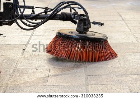 Vehicle sweeping the streets of dirt in the Spain