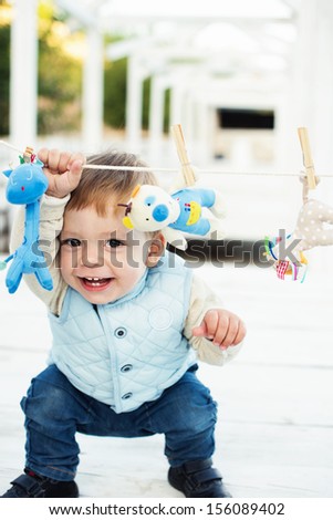 little boy with toy smiling