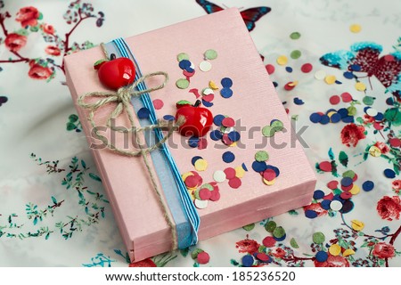 decorated present box  with a red apples and a bow