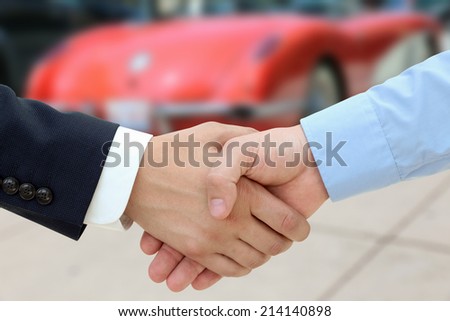 Close-up image of a firm handshake  after a successful deal of buying a car