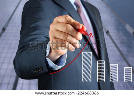 Businesswoman  drawing a virtual  graph by  a red pen