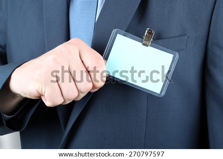 The business man showing a  Blank Badge