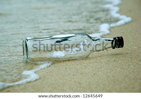 A bottle in the beach and sea foam