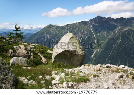 Granite rock on high plain in French Alps with view on mountains on other side of Chamonix valley