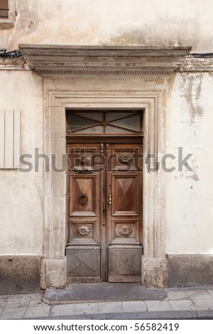 Dilapidated wooden 18Th century door in the city center of Apt, Provence, France