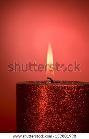 a red candle on red background