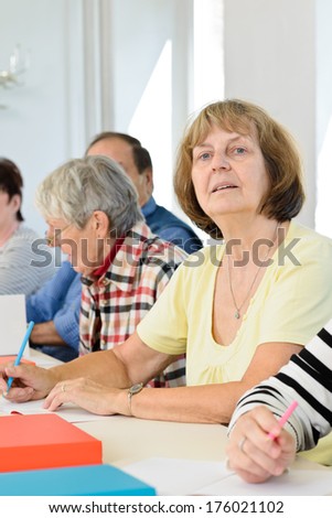 A group of elderly people sitting at a table.