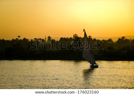 A sail boat on a body of water.