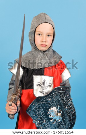A young boy with his sword and shield.