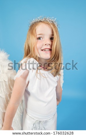 A little girl with a halo and angel wings.