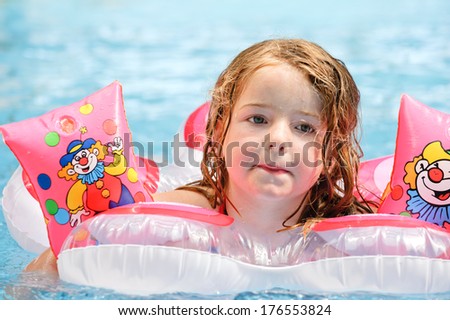 A girl floating on an inflatable toy in the water.