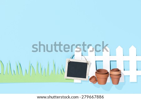 white paper fence and green grass with flower pots and a tag on blue background