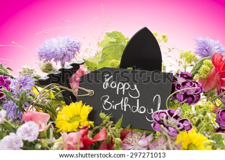a close up of a bouquet of flowers with a black label saying: \