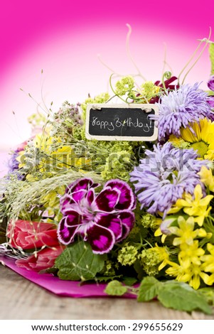 a bouquet of flowers with a tag saying: 