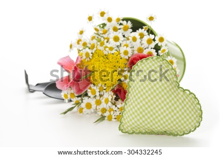 handmade heart with flowers and gardening tools on white background