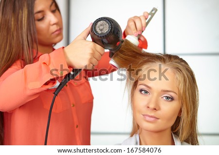 Hair salon. Women haircut. Use of hair dryer.