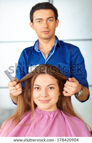 Hair salon. Woman haircut. Combing.