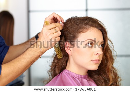 Hair salon. Woman haircut. Combing.