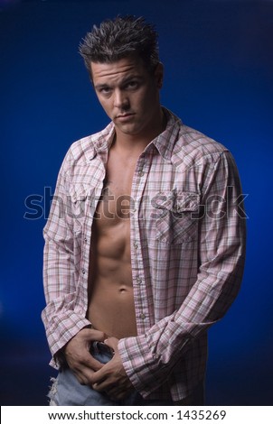 cut male model in studio with shirt open