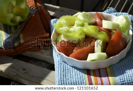 Healthy dinner: green salad with tomatoes and cucumber