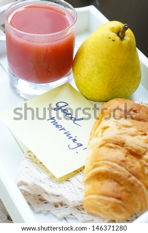 Healthy breakfast: juice, pear and croissant  crescent roll