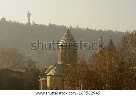 Misty morning in Old Tbilisi with view of Narikala castle and domes of ancient churches