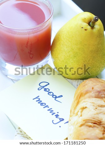 Healthy breakfast: juice, pear and croissant  crescent roll