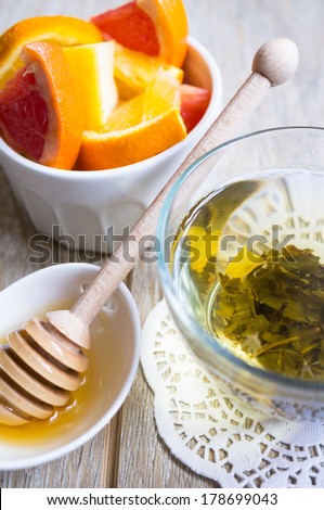 Cup of green tea, fresh fruits and honey