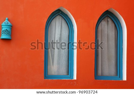 Arabic architecture: two windows and lamp on the red wall