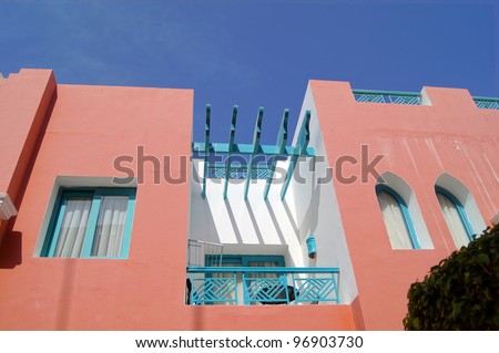 Arabic architecture: red walled villa and blue sky