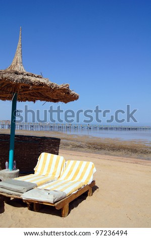 Sun beds and umbrella on the sea beach