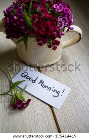 Good morning note and flowers in a vase