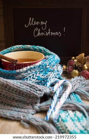 Red ceramic cup with tea and lemon, Merry Christmas sign made with chalk, and christmas decoration