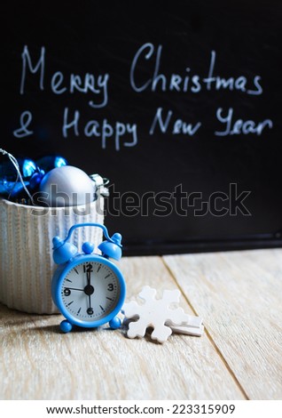 Chalk board with holiday time wishes and christmas decorations