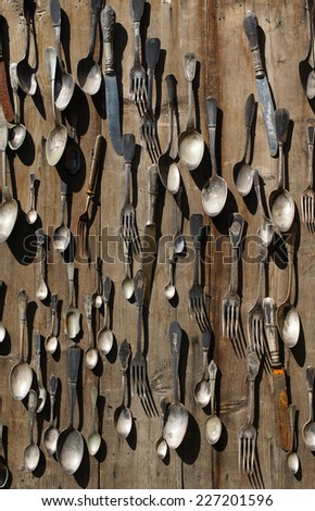 Background of vintage silverware: spoons, teaspoons, knifes, forks and other cutlery on a flea market table