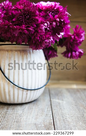 Purple chrysanthemum flowers in a vase on the table