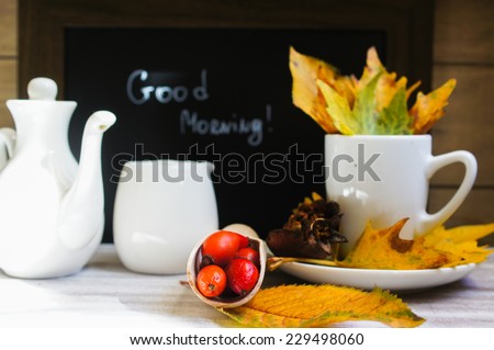 Hot hip tea with berries and Good morning note on a chalkboard