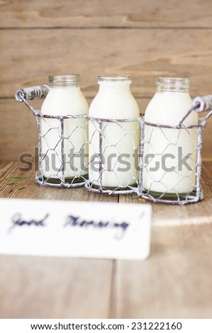 Crate of vintage milk bottles in rustic setting