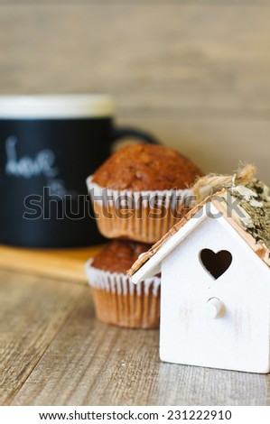 A mug with Love is note and valentine decoration on the wooden table