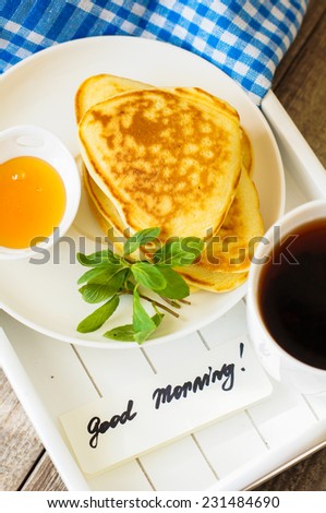 Pancakes with honey and jam with cup of tea for healthy breakfast