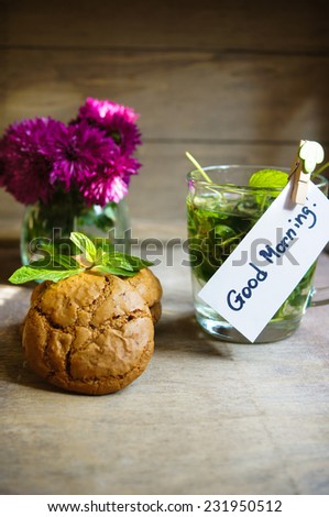 Mint tea and cookines with Good morning note on the wooden background